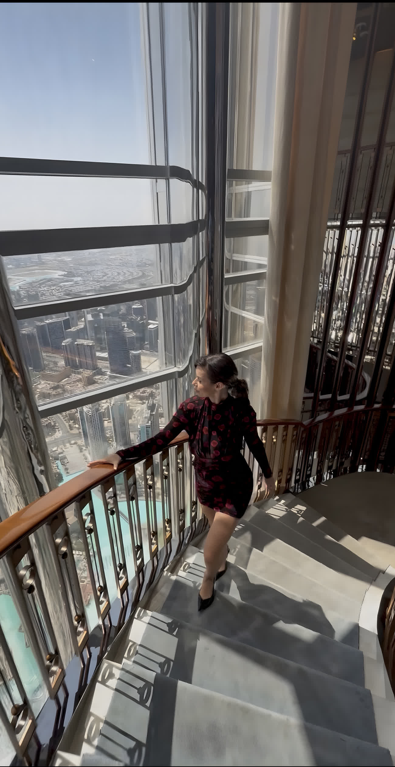 Julita on a staircase high above Dubai